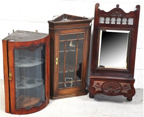 A small oak glazed corner wall unit, a mahogany glazed bow fronted wall hanging corner cupboard and a mahogany wall mirror wi