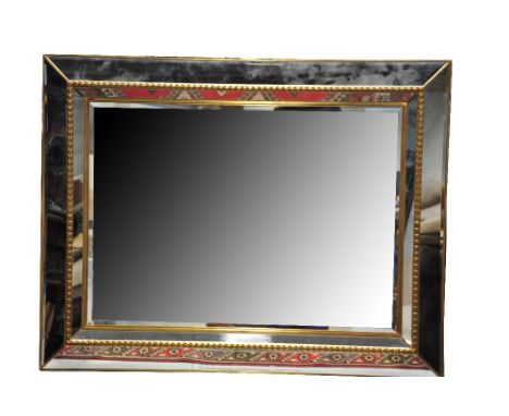 A large modern bevelled wall mirror with faceted surround, length 133cm.