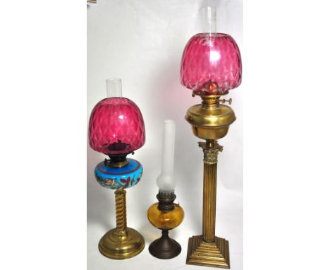 An early 20th century glass oil lamp with classical style column, height 86cm, a further 20th century oil lamp with blue hand