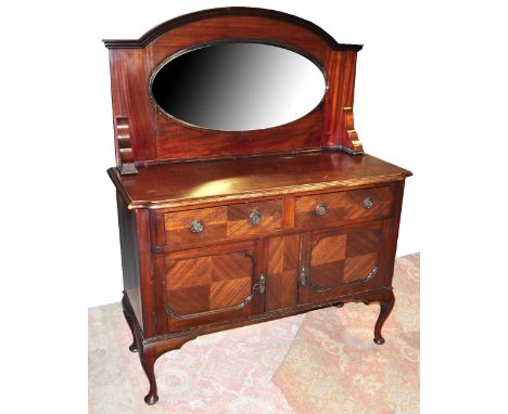 An Edwardian mahogany mirror back sideboard with two short drawers set above two larger cupboard panels raised on pad feet, w
