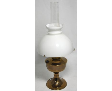 A brass oil lamp with opaque glass shade, height 61cm.