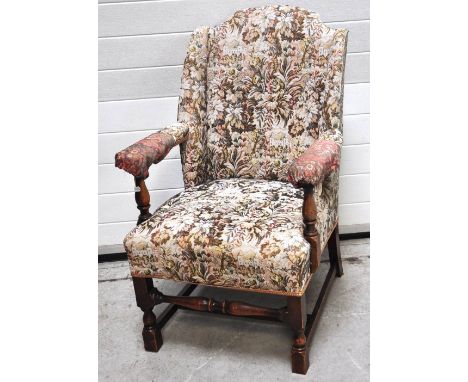 An Edwardian oak  armchair with tapestry upholstery.