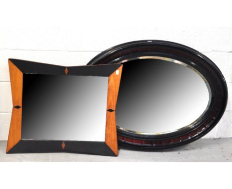 A large oval mahogany framed mirror, width 94cm (af) and a retro 1960s pale oak and black fabric rectangular shaped mirror, w