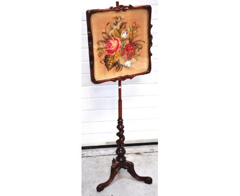 A Victorian walnut face screen on carved tripod base, tapestry screen decorated with beaded roses, height 145cm.