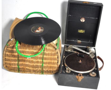 A  boxed, "The Answers" portable wind-up record player and a quantity of 78s. CONDITION REPORT Some age related wear. Unteste