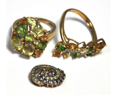 A 9ct gold ring set with green peridot stones, size M, a further 9ct gold ring set with green white and amber coloured stones