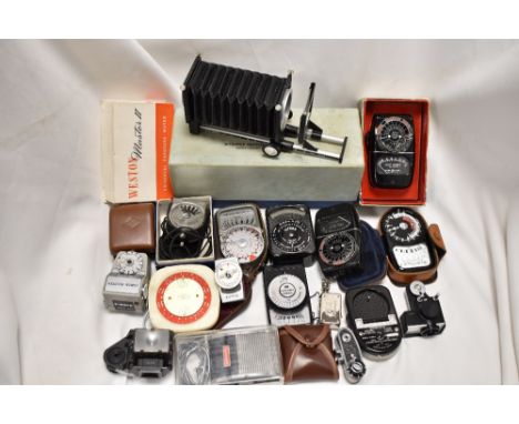 A box of various light meters and focus bellows etc