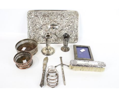 Collection of silver and plated items. Including a hallmarked candlestick, brush and a heavily embossed plated tray, etc. Max