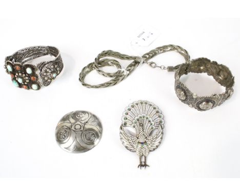A small collection of Middle Eastern and other jewellery including an articulated and enamelled peacock brooch. Marked 'Watan