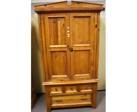 A contemporary stained pine wardrobe. With two panel doors and drawers beneath. L107cm x D61cm x H202cm