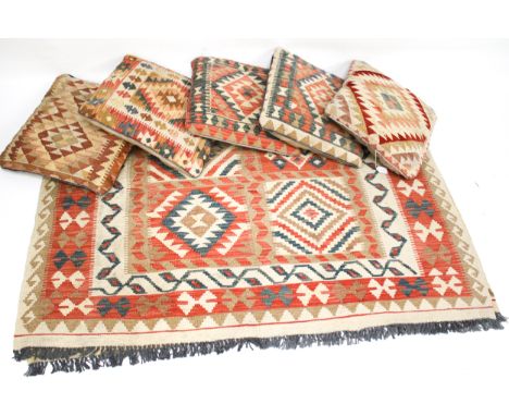 A contemporary kilim style rug and five similar tapestry cushions. Rug size 200cm x 150cm