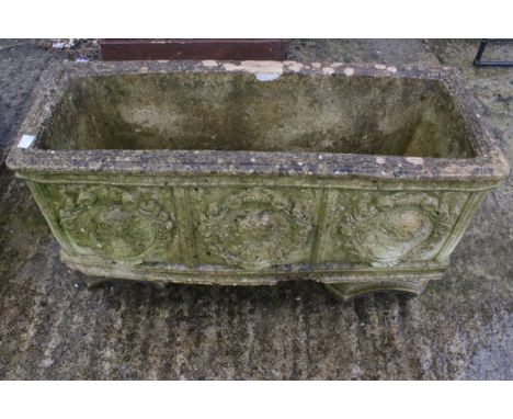 A composite stone oblong planter on stand. Decorated with classical scenes, H40cm x W69cm x D27cm