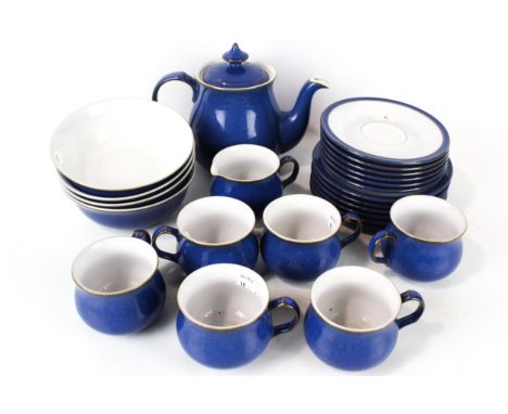A vintage Denby Pottery tea service. Glazed in blue and white including cups and saucers, plates, bowls, etc.
