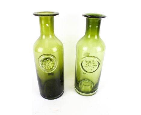 A pair of vintage Dartington green glass bottles. H30cm