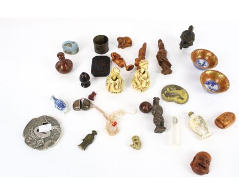 A collection of small interesting Japanese and Asian items. Including a fruitwood netsuke in the form of Hotei; anther signed