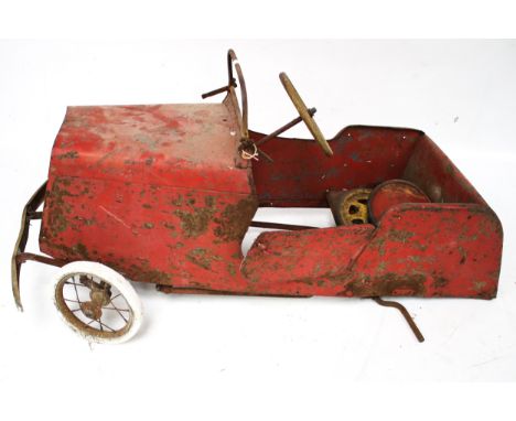 A child's vintage red metal ride on pedal car. L99cm x D41cm x H48cm Condition Report: No back wheels 