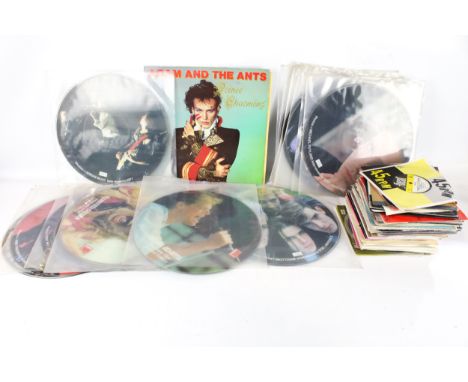 A collection of vintage vinyl records. Including 33 RPM 'picture disc', LPs, Rock and 45 RPM 7" singles etc.