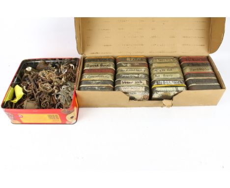 A collection of vintage metal hardware items. Including keys, nuts and bolts in old tobacco tins. 