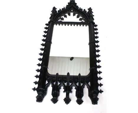 A large contemporary Gothic Revival rectangular wall mirror. With carved and pierced decoration and arched top flanked by pil