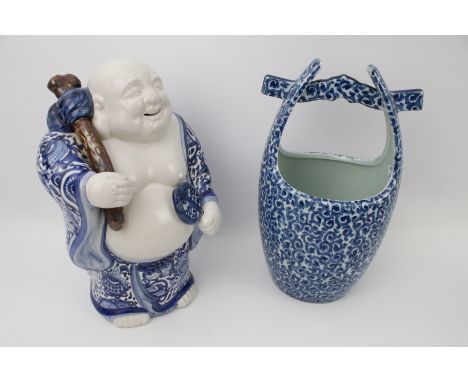 A blue and white glazed ceramic laughing buddha and a ceramic well bucket. Max H31cm