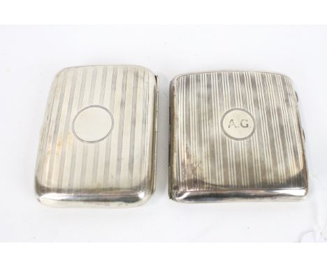 Two silver concave cigarette cases, each with engine turned bands. Comprising: one oblong with a round reserve with initials 