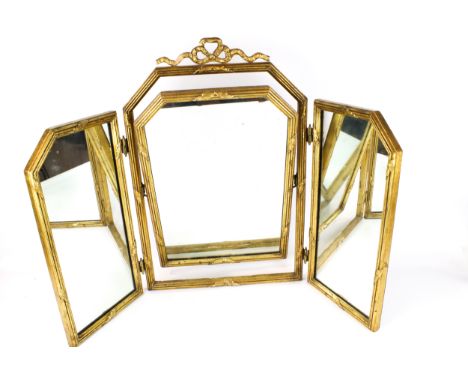 A gilt framed triple folding dressing table mirror. The frame surmounted by a ribbon, H63.5cm