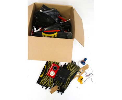 An assortment of Scalextric track and accessories. Including controllers, lapcounters, etc.