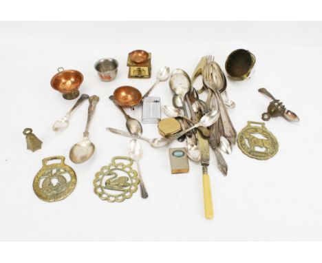 A small assortment of silverplated and brass items. Including flatware, a lighter, horse brass etc. 