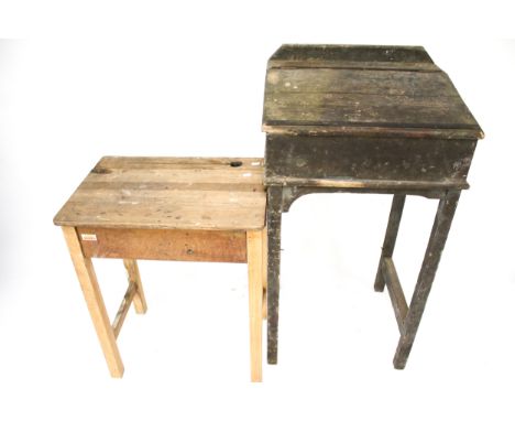 Two vintage wooden school desks. Comprising a clerk's desk with a sloped lid, H111cm x W61cm x D51cm, the other a pine child'