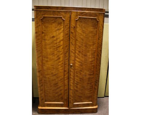 A vintage satin birch wardrobe. The pair of panelled doors opening to reveal four sliding shelves and three drawers to the le