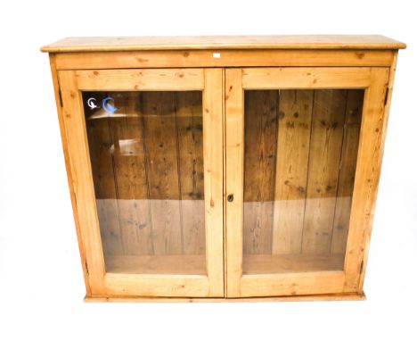 A vintage oak display cabinet. The two glazed doors opening to reveal two shelves, H125cm x W143cm x D32cm