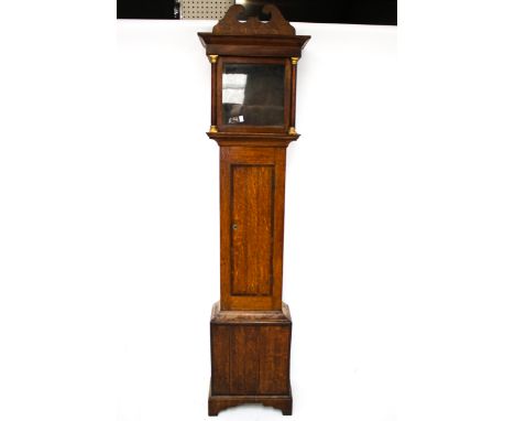 A Victorian oak long case clock case. The hood with a swan neck pediment and the face flanked with columns, raised on bracket