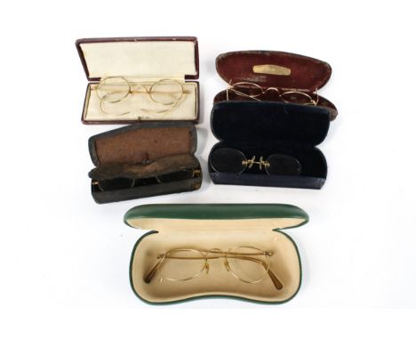 Five pairs of vintage yellow metal wire frame glasses/ pince nez spectacles. In fitted boxes