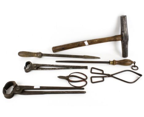 A collection of assorted Blacksmith's tools and hammer. Including tongs and a file, etc.