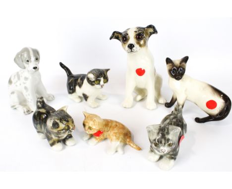 Seven ceramic kittens and puppies. Comprising a Beswick siamese cat, four Winstanley cats with glass eyes, a Winstanley dog w