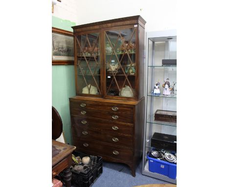 A GEORGE III MAHOGANY SECRETAIRE BOOKCASE with glazed doors above enclosing adjustable shelves over a secretaire drawer with 