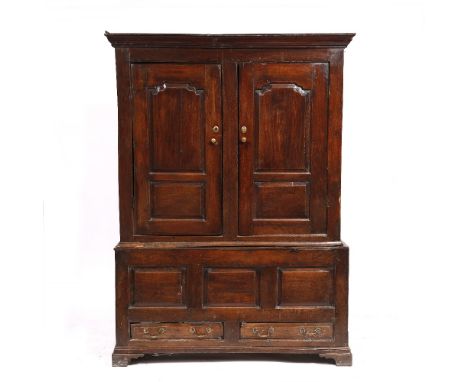 AN 18TH CENTURY WELSH OAK PRESS CUPBOARD with panelled doors above a recessed base with panelled front and two drawers standi