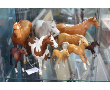 EIGHT BESWICK HORSES of varying sizes and a Royal Doulton horse, together with a blue and white pottery tea service