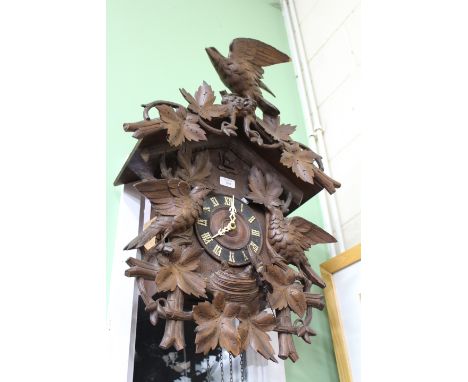 A 19TH CENTURY BLACK FOREST CUCKOO CLOCK 72cm approximately