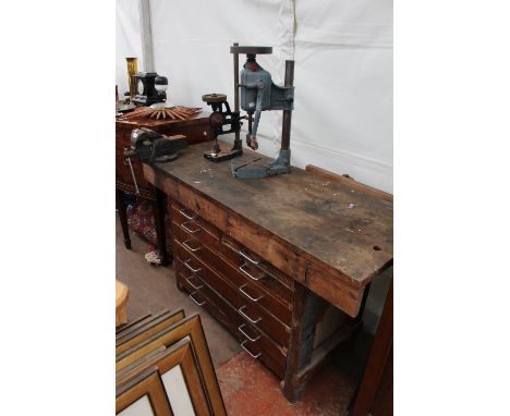 AN OLD WORK BENCH with four short and four long drawers, 137cm in length together with a record number 3 vice and two pillar 