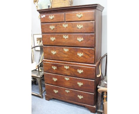 A GEORGE III MAHOGANY AND OAK CHEST ON CHEST with two short and six long drawers with brass escutcheons and handles, all rais