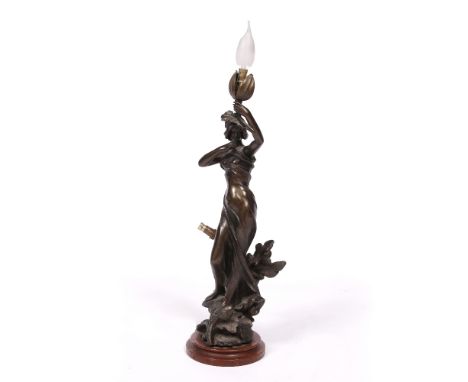 A SPELTER TABLE LAMP in the form of young woman holding a branch aloft, mounted on a turned marble socle, 55cm high