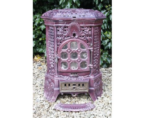 A FRENCH PURPLE ENAMEL HEXAGONAL WOOD BURNING STOVE with pierced decoration and applied flower heads, 45cm wide x 32cm deep x