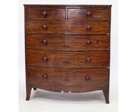 A VICTORIAN MAHOGANY BOW FRONTED CHEST OF TWO SHORT AND FOUR LONG GRADUATED DRAWERS all with turned knob handles and splayed 