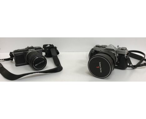 A collection of cameras and equipment to include an Olympus E-P2 with an Olympus M.Zuiko digital 14-150 mm lens, an Olympus O