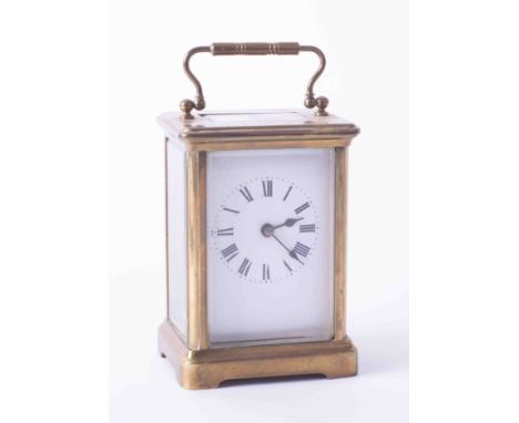 A French brass faced carriage clock with platform escapement, two keys, hairline crack to dial.