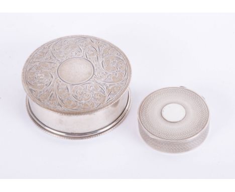 A circular silver pill box, marked 'GFW' together with a small silver and engine-turned circular snuff box (2).