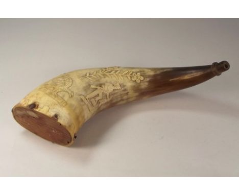 COW HORN FLASK.
A cow horn powder flask, naively carved with a huntsman holding a rifle, two eagles, deer, flowers & birds. L