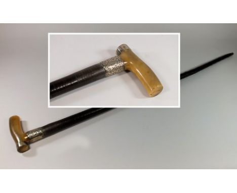 WALKING STICK.
An Edwardian silver mounted, horn handle walking stick, the shaft of tapering leather washers. 