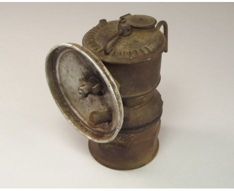 MINER'S LAMP.
A 1930s miner's carbide hat lamp by Premier. Height 10cm. NOTE: This lamp was last used in Geevor Mine, Cornwal